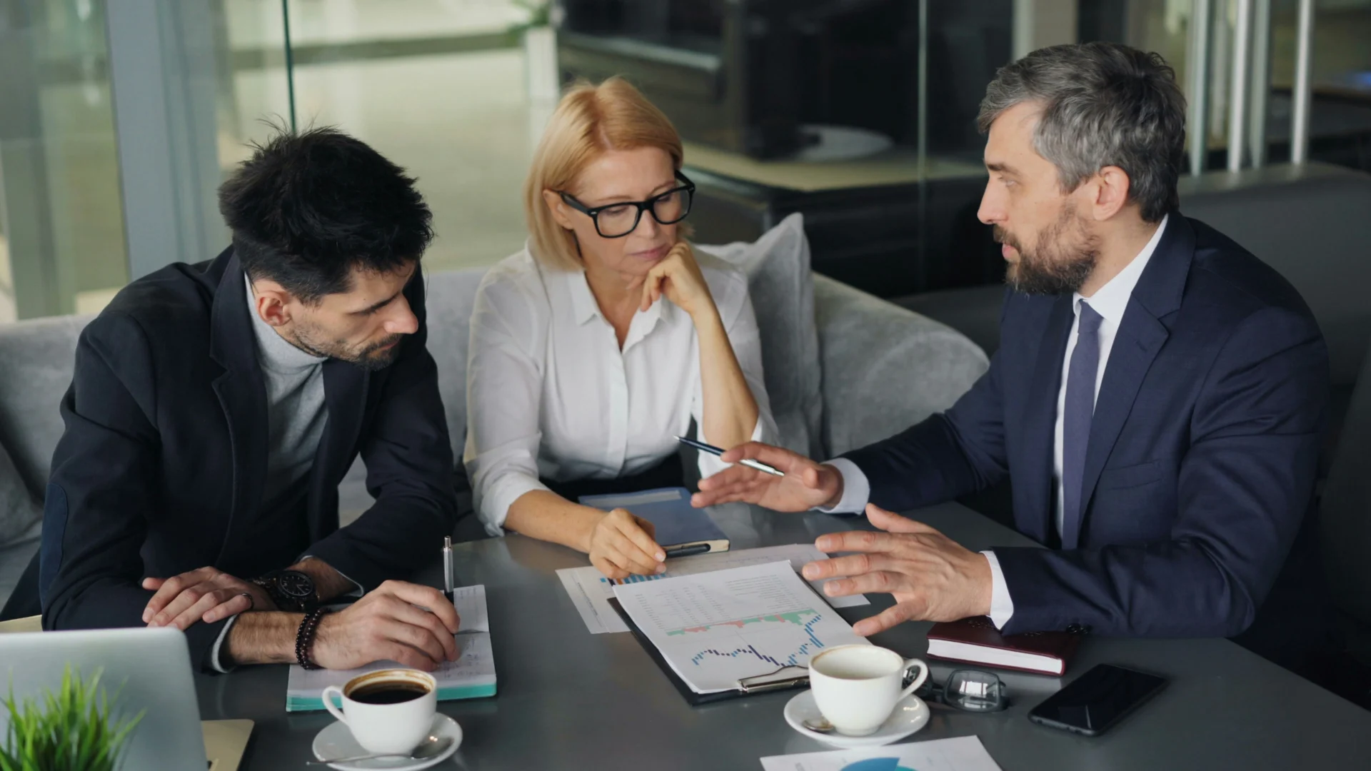 Business professionals comparing AI search vs organic search visibility using performance charts