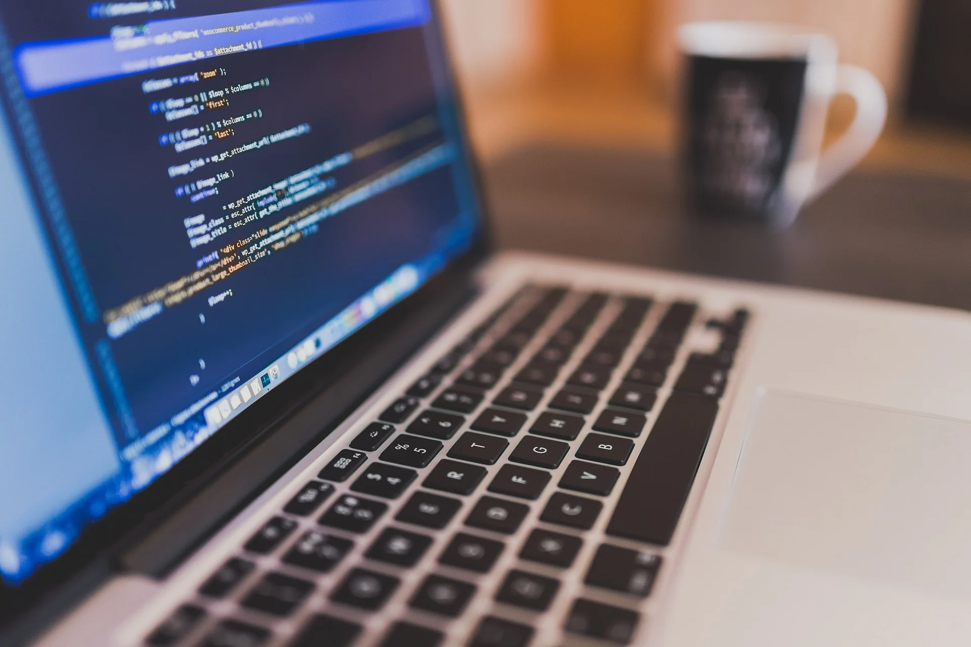 Developer's laptop displaying code used during a GEO content audit for high-volume search queries